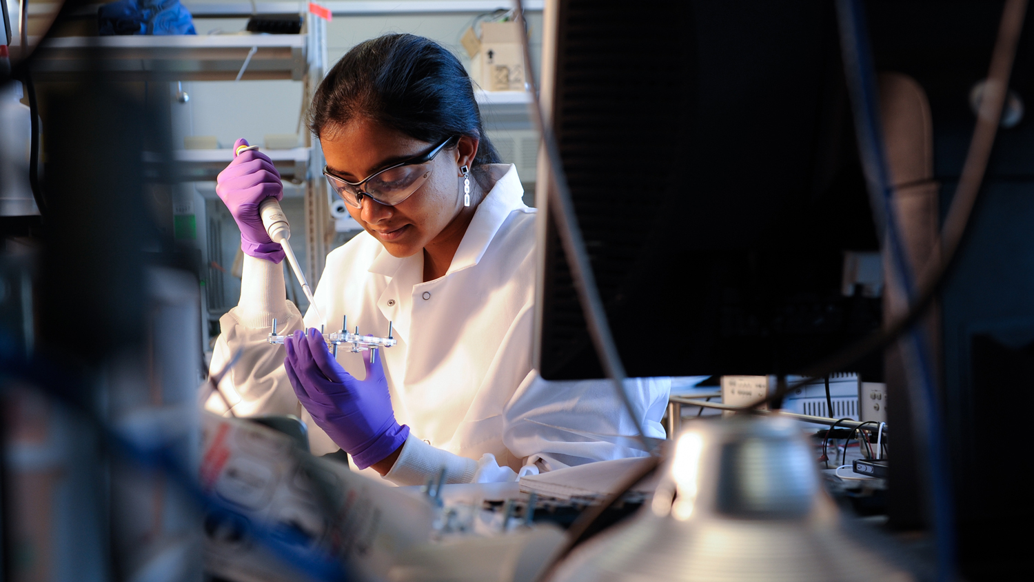 researcher with test tubes in lab