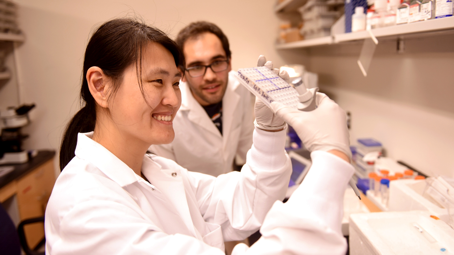 scientists in lab with test tubes