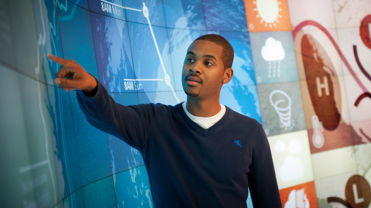 faculty member in front of visualization screen