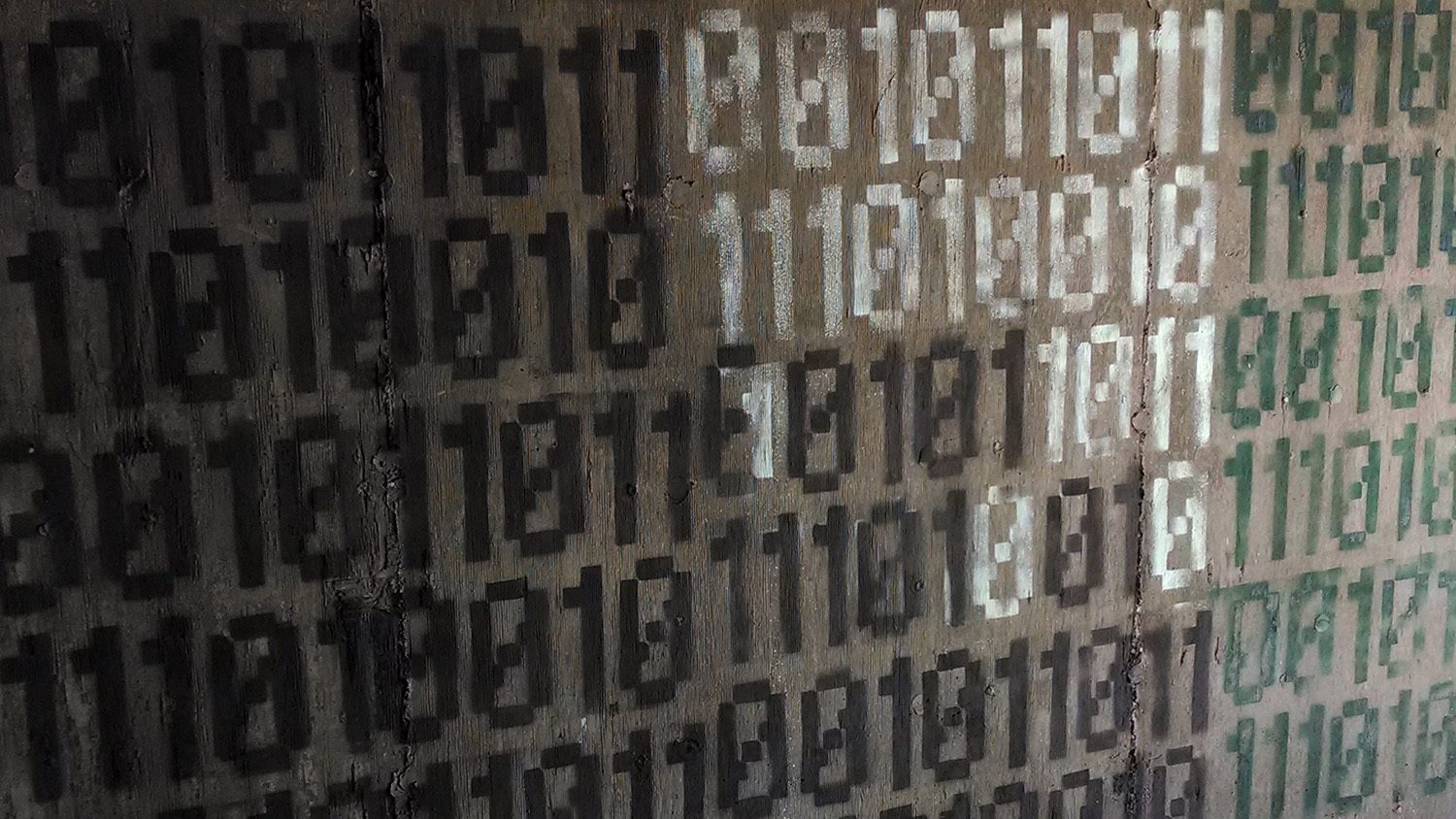 binary code spraypainted on wall